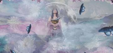 A woman in the foreground and a floral display in the background with stars and the expanse of space