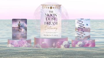 A book with the words The Moon Dust Dream Dictionary and tarot cards